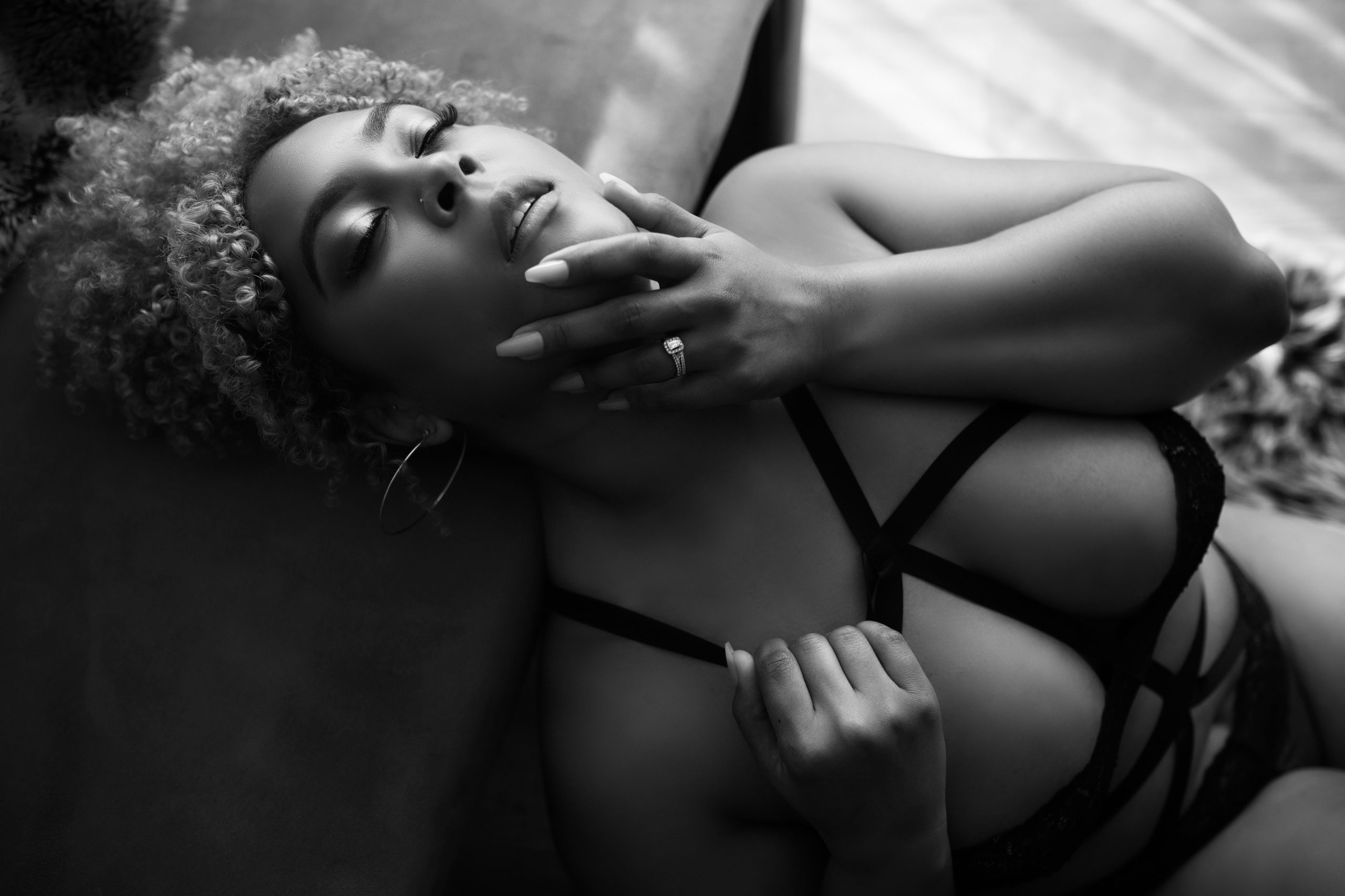 woman caressing her face in laying pose boudoir posing ideas from maryland photographer Boudoir by Veronica